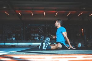 man-sitting-on-exercise-mat-lxgf3oyqo6k